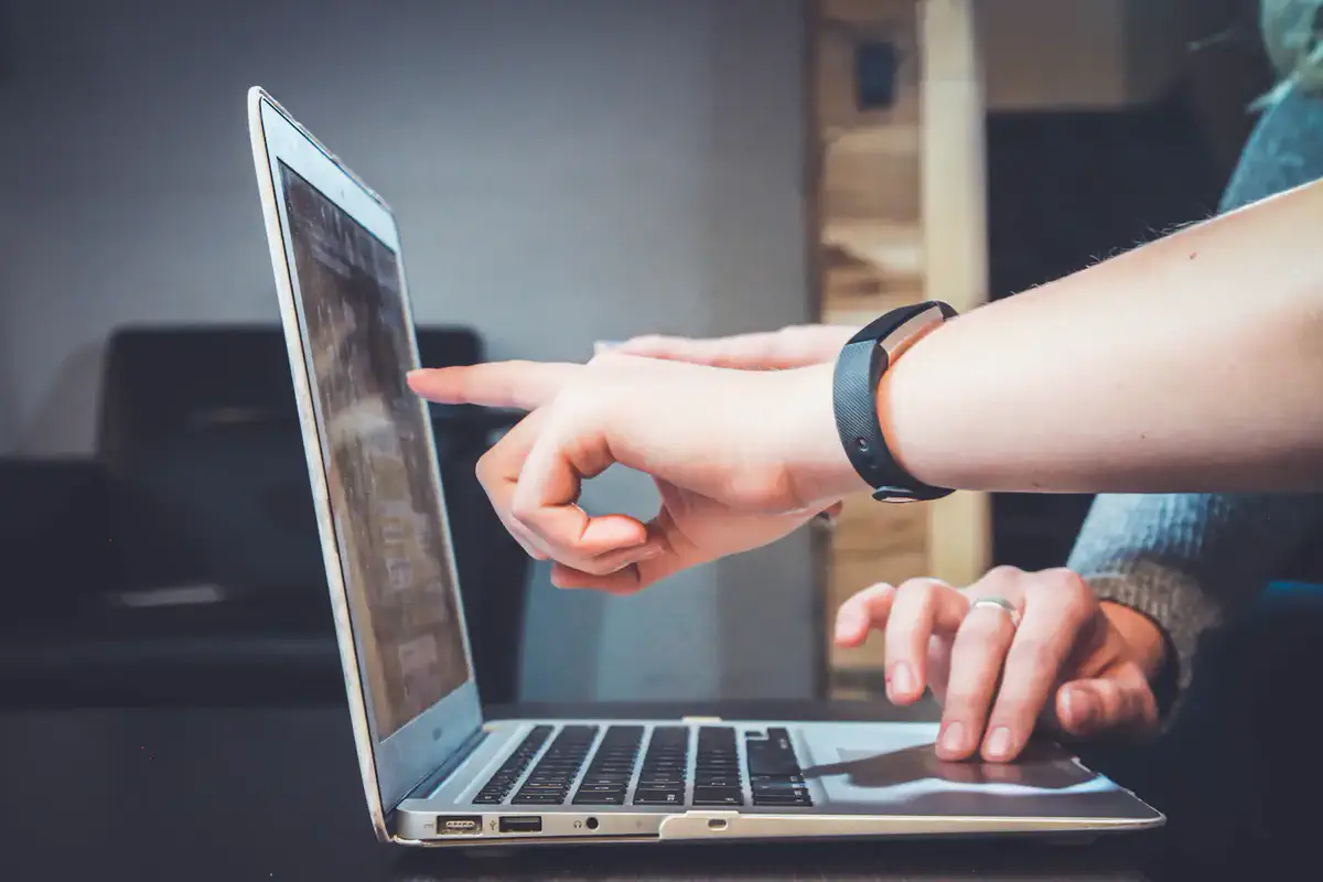 Two people reviewing campaign performance on a laptop